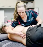  ??  ?? Albert Street Sports & Spinal Injury Centre physiother­apist Samantha Moore performing a spinal assessment.