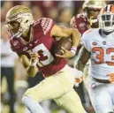  ?? PHIL SEARS/AP ?? Florida State quarterbac­k Jordan Travis scores his second rushing touchdown of the season in the first half Saturday against Clemson.