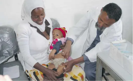  ??  ?? A doctor tends to a mother and child at the Addis Ketema Health Centre in Ethiopia’s capital, Addis Ababa.PHOTOS: DAVID ZAKUS