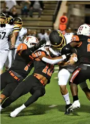  ?? Photo by Kevin Sutton ?? Texas High defenders Jaylen Green (1), Clayton Smith (10) and Javarous Tyson (27) converge to stop a Denison player Friday night at Tiger Stadium in Grim Park in Texarkana.