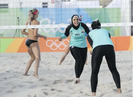  ?? MARCIO JOSE SANCHEZ, THE ASSOCIATED PRESS ?? Until four years ago, women athletes competing in beach volleyball at the Olympics were required to wear bikinis. Many, including this Canadian playing the much-more-covered Egyptian team, still do.