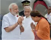  ?? PTI ?? Prime Minister Narendra Modi being received by Rajasthan governor Kalyan Singh and chief minister Vasundhara Raje on his arrival at Dabok Airport in Udaipur on Tuesday. —