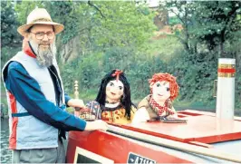  ??  ?? Cunliffe steering the barge with Rosie and Jim and, below, Postman Pat, his most famous creation