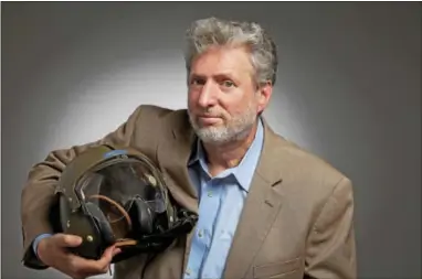  ?? SUBMITTED PHOTO ?? David Venditta, holding the flight helmet of his cousin, Nicholas L. Venditti, who died in Vietnam in 1969.