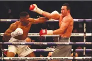  ?? AP/MATT DUNHAM ?? Anthony Joshua (left) knocked out Wladimir Klitschko with an uppercut in the 11th round Saturday in London.