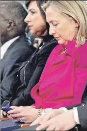  ??  ?? Where’s the “delete” button? Then-Secretary of State Hillary Clinton checks her Blackberry phone at a forum in South Korea in 2011.