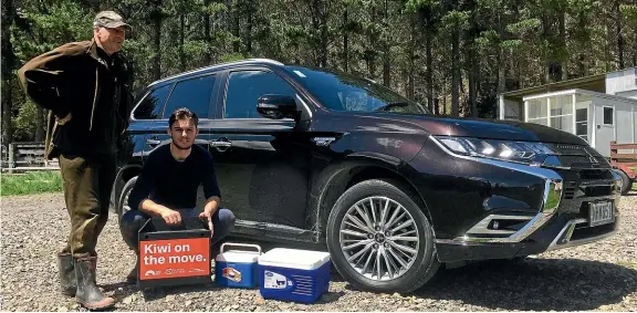  ?? ROB MAETZIG/STUFF ?? Kiwi expert Sid Marsh and Experience Pu¯rangi ranger Jayden Fabish alongside the Outlander PHEV with the kiwi eggs and the chick, all packed up and ready to go.