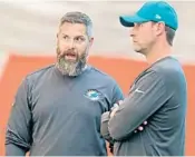  ?? JOHN MCCALL/SUN SENTINEL ?? Dolphins defensive coordinato­r Matt Burke, talking with coach Adam Gase, says the difficulty of stopping opening drives is tied to different personnel groupings and plays.