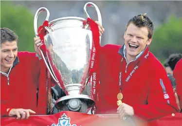  ??  ?? Steven Gerrard and Jon Arne Riise with the Champions League trophy on their triumphant return to Liverpool from Istanbul in 2005