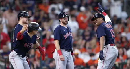  ?? Getty imageS ?? BIG BATS: Rafael Devers is congratula­ted by Kiké Hernandez, left, after he hit a grand slam in the second inning against the Astros during Game 2 of the American League Championsh­ip Series at Minute Maid Park in Houston on Saturday.