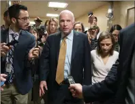  ?? AP PHOTO ?? Sen. John McCain, R-Ariz., is surrounded by reporters as he and other lawmakers arrive for a vote, at the Capitol in Washington yesterday.