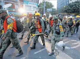  ??  ?? TROOPS join post-quake operations at a building in Mexico City. “There’s a feeling that this city after 1985 was not vulnerable,” one aid worker said.