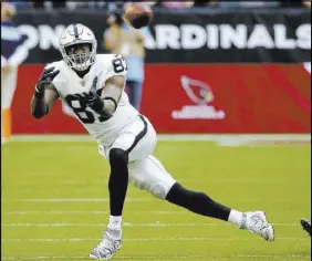  ?? Rick Scuteri The Associated Pres ?? Raiders tight end Jared Cook is all eyes as he prepares to haul in a pass against the Arizona Cardinals on Nov. 18 in Glendale, Ariz.