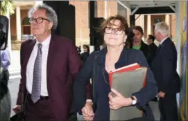  ?? BRENDAN ESPOSITO — AAP IMAGE VIA AP ?? Australian actor Geoffrey Rush, left, and his wife Jane Menelaus leave the Federal Court in Sydney, Wednesday.