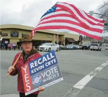  ?? RICH PEDRONCELL­I/AP PHOTOS ?? John Deaton joins others in a Feb. 20 rally in Redding, California, calling for the recall of Shasta County 1st District Supervisor Kevin Crye, who voted to get rid of the county’s ballot-counting machines in favor of hand counts.