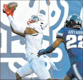  ?? Eli Lucero The Associated Press ?? UNLV wide receiver Kyle Williams hauls in a touchdown pass as Utah State cornerback Michael Anyanwu comes up short on defense as the Rebels improve to 3-1 overall and 1-0 in Mountain West play with a 34-24 victory Saturday in Logan, Utah.