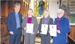  ??  ?? Dr Barr gives Evelyn, Kate and Eleanor their certificat­es.