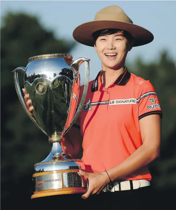  ?? — THE CANADIAN PRESS ?? Sung Hyun Park of South Korea borrowed a Mountie’s dress hat after winning the 2017 Canadian Pacific Women’s Open in Ottawa on Sunday.