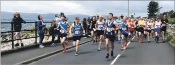  ?? 01_B27maratho­n03 ?? And they are off – runners set off at the start of the race.