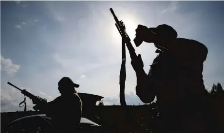  ?? MICHAL DYJUK/AP ?? Belarusian volunteers who are training to fight Russian forces in Ukraine practice on Friday at a shooting range near Warsaw, Poland.