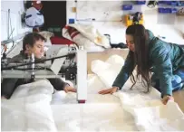  ??  ?? Above: Max and Chloë re-stitch sails in Newlyn’s Solo Sails loft, while Vanessa Mancini helps with the varnishing work (right)