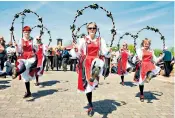  ??  ?? Move with the times: traditiona­l English Morris dancers performing in Thaxted, Essex in recent years and in the Fifties, top; and female Morris dancers at Uptonupon-severn, Worcs, above