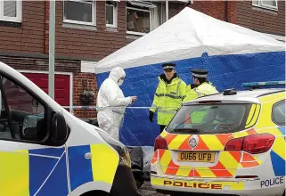  ??  ?? Probe...police outside the terraced house where three family members were killed