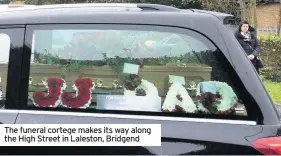  ??  ?? The funeral cortege makes its way along the High Street in Laleston, Bridgend