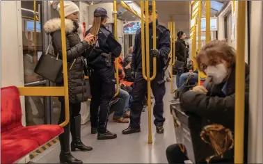  ?? Police officers stand inside a metro train, following an outbreak of coronaviru­s disease (COVID-19) in Warsaw, Poland on Saturday. REUTERS ??