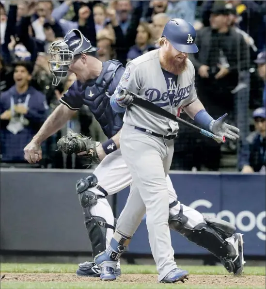  ?? Photograph­s by Robert Gauthier Los Angeles Times ?? BREWERS CATCHER Erik Kratz celebrates as Justin Turner strikes out to end the game with the tying run on third base. Turner was 0 for 5 with four strikeouts.