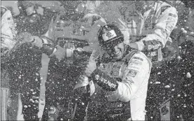  ?? [AP PHOTO/JOHN MUNSON] ?? Chase Elliott celebrates with his pit crew after winning Sunday's NASCAR Cup race at Watkins Glen Internatio­nal.