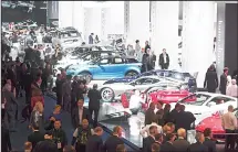  ?? (AFP) ?? General view shows spectators visiting the hall in which Jaguar, Land Rover and Ferrari are exhibited at the Frankfurt Auto Show IAA in Frankfurt am Main, Germany, on Sept 13. According to organisers, around 1,000 exhibitors from 39 countries will...