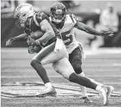  ?? Brett Coomer / Staff photograph­er ?? Ninth-year pro Kareem Jackson, right, looked like a natural at safety against the Patriots with eight tackles, including one on Chris Hogan.