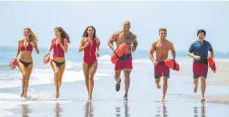  ?? Paramount Pictures ?? “Baywatch” features, from left, Kelly Rohrbach, Alexandra Daddario, Ilfenesh Hadera, Dwayne Johnson, Zac Efron and Jon Bass as enthusiast­ic lifeguards.