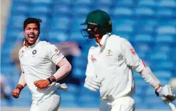  ?? PTI ?? India’s Umesh Yadav celebrates the wicket of Australia’s Nathan Lyon at the Maharashtr­a Cricket Associatio­n stadium in Pune. Yadav accounted for four wickets.