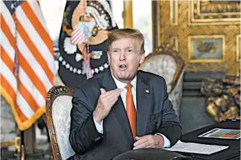  ?? NICHOLAS KAMM/GETTY-AFP ?? President Trump answers questions from reporters Tuesday after making a video call to U.S. troops stationed worldwide.