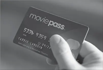  ?? Associated Press ?? ■ Cassie Langdon holds her MoviePass card outside AMC Indianapol­is 17 theatre in Indianapol­is. With MoviePass, Langdon said she’s taking more chances on smaller releases instead of sticking with blockbuste­rs and their sequels.