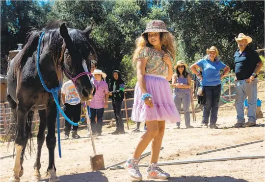  ?? JESSICA PARGA U-T PHOTOS ?? Melody Andraca, 10, leads a horse at Heart-N-Soul Equine Assisted Therapy recently as part of a San Diego American Indian Health Center youth group visit.