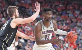  ?? STEPHEN R. SYLVANIE/USA TODAY ?? Deandre Ayton, guarded by Colorado’s Lucas Siewert, and Arizona’s other starters scored in double figures in the 83-67 win.