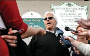  ??  ?? EARLY LIAISON: Trainer Bob Baffert talks to the media after Kentucky Derby hopeful Liaison worked out Monday at Churchill Downs in Louisville, Ky. Baffert, who suffered a heart attack earlier this year in Dubai, also trains Bodemeiste­r, a Derby...