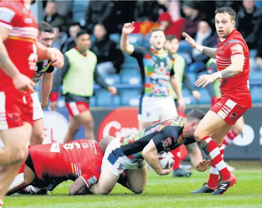  ?? Jackie Meredith ?? Salford Reds Robert Lui brings down Lewis Galbraith