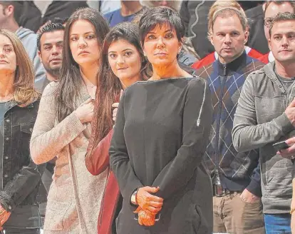 ??  ?? Kris Jenner attends a Clippers game with daughters Khloe (left) and Kylie in November. As she blasts false reporting about her family, a pal says it’s “the price you pay for being in the public eye.” | ANDREW D. BERNSTEIN~NBAE
FAMILY FOCUS: