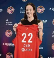 ?? Darron Cummings/Associated Press ?? Indiana Fever’s Caitlin Clark holds her jersey following a WNBA basketball news conference on April 17.