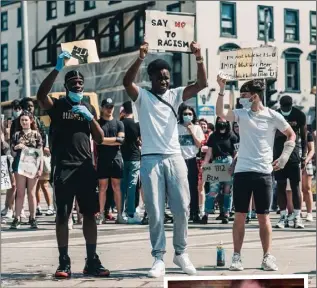  ??  ?? The photo of Kiitan Amao, Moyo Budun and Sean Hill at the Black Lives Matter protest in Dundalk taken by Fra Lucchesi which has got more than a million likes, with insert, a picture of the three as young boys.