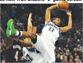  ??  ?? MINNESOTA TIMBERWOLV­ES forward Andrew Wiggins (22) passes the ball to guard Brandon Rush (not pictured) in the third quarter against the Portland Trail Blazers at Target Center.