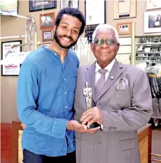  ?? — AFP photo ?? Filmmaker Kris Bowers (left) and Horace Bowers, Sr pose at a press event for the Oscar-nominated short film ‘A Concerto is a Conversati­on’ at Bowers & Sons Cleaners in Los Angeles, California.