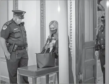  ?? AP-J. Scott Applewhite, File ?? In this Jan. 12 file photo, Rep. Marjorie Taylor Greene, R-rome, passes through a metal detector before entering the House chamber, a new security measure put into place after a mob stormed the Capitol, in Washington.