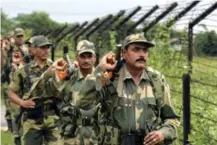  ?? ARIS MESSINIS/AFP/GETTY IMAGES ?? Indian Border Security Force soldiers patrol the fenced border with Bangladesh in Fulbari village.