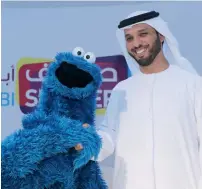  ?? — Photo by Ryan Lim ?? Mubarak Al Shamsi with Puppet Cookie Monster during the Press conference to announce the Abu Dhabi Summer Season, to be held from July 20 to August 20.