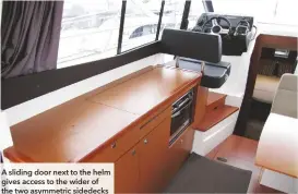  ??  ?? A sliding door next to the helm gives access to the wider of the two asymmetric sidedecks